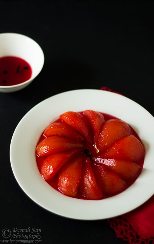 Poached pears in white wine served in a glass bowl