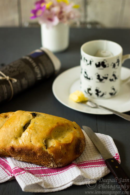 Olive bread loaf cooling on a wire rack