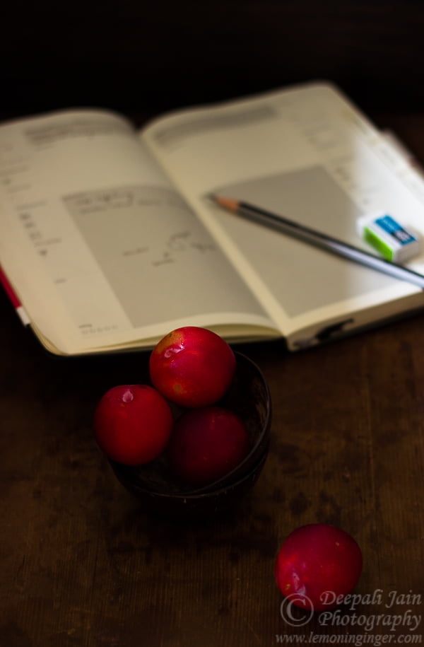 Ceramic ramekin filled with individual servings of apple plum crisp
