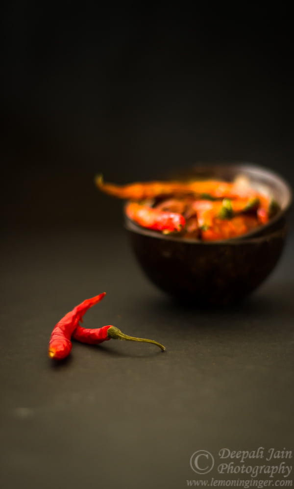 A zoomed-in view of red chilies with wrinkled skins indicating proper drying