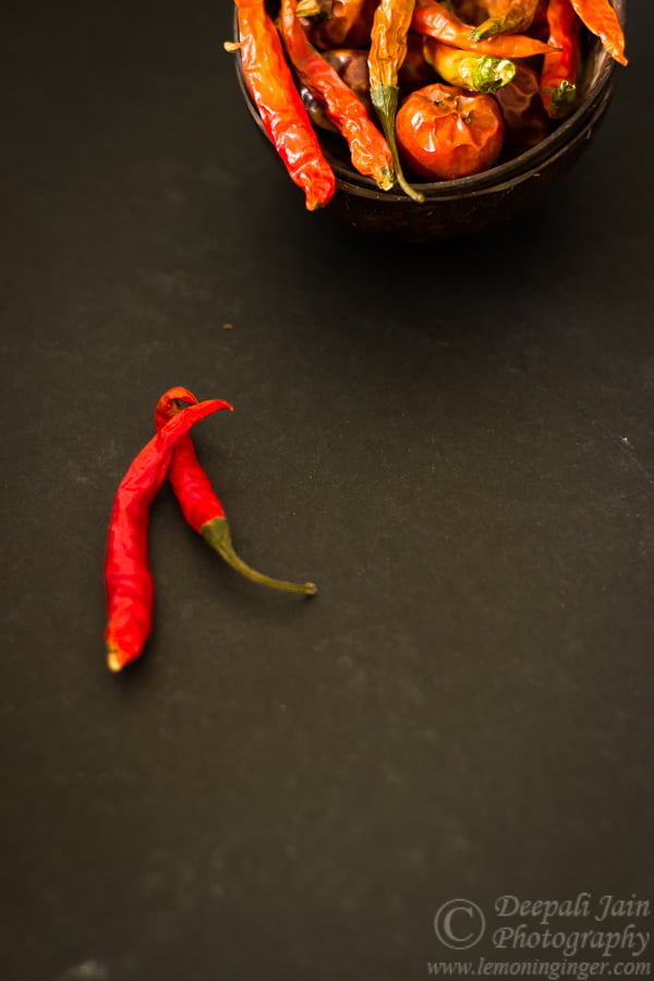 A zoomed-in view of red chilies with wrinkled skins indicating proper drying