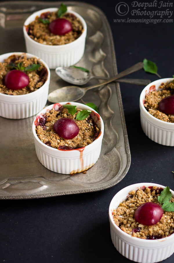 Rustic presentation of plum and apple crumble in a wooden bowl