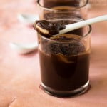 Spoon scooping a silky dark chocolate mousse, revealing its smooth texture