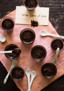 Layers of dark chocolate mousse and crushed cookies in a transparent dessert glass