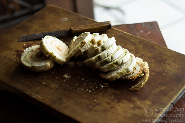 Thinly sliced vegetables placed on the bread for pinwheel sandwiches
