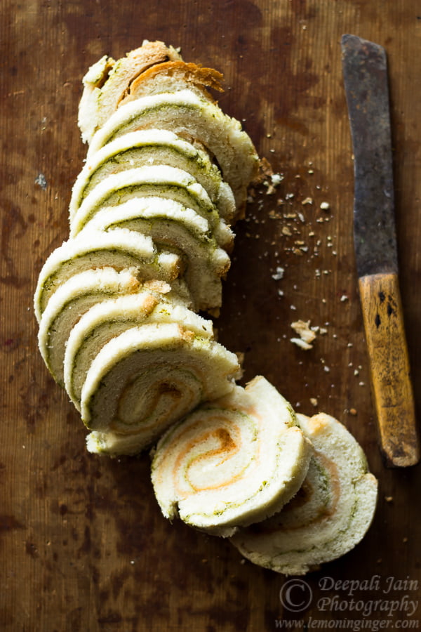 Pinwheel sandwiches arranged in a circular pattern on a wooden board