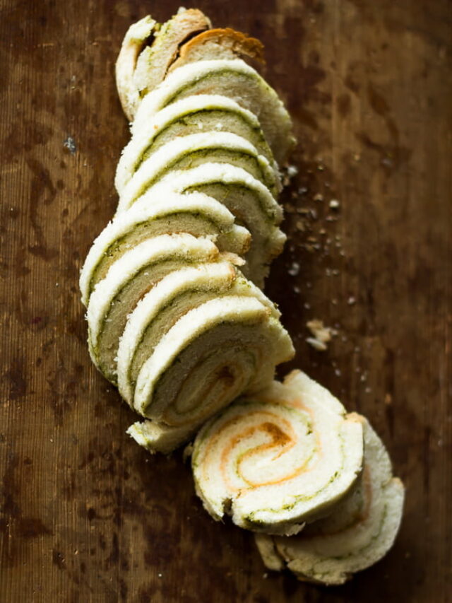 Pinwheel sandwiches served with ketchup and mint chutney