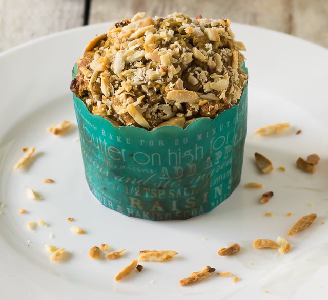 A close-up of freshly baked Eggless Date and Walnut Cupcakes topped with chopped walnuts