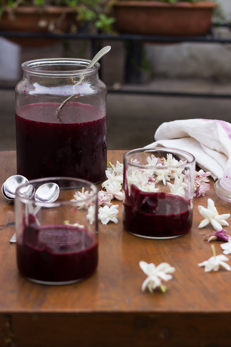 Close-up of Kanji in a glass jar with vibrant beetroot and carrot slices immersed in pinkish brine