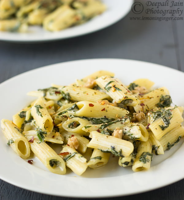 Close-up of creamy spinach pasta topped with grated Parmesan cheese
