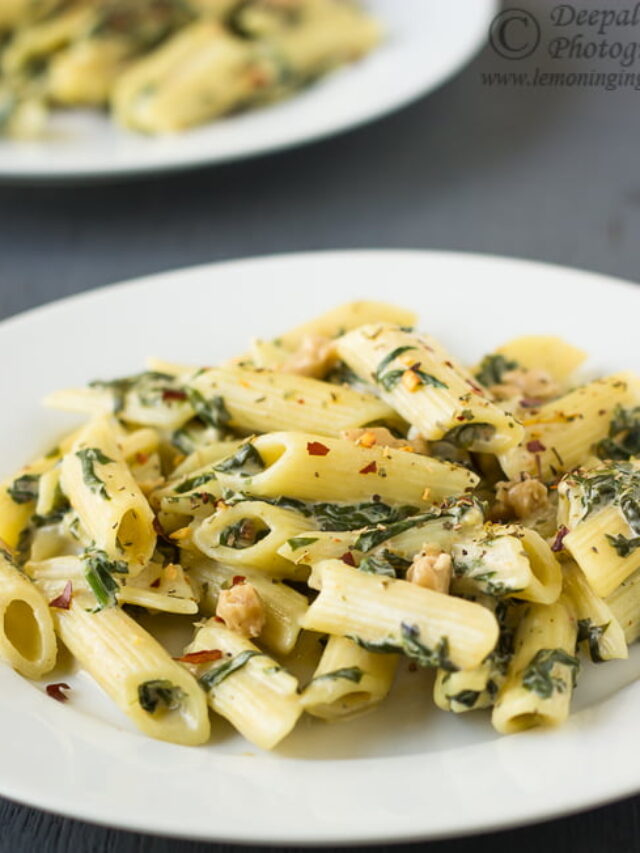 Close-up of creamy spinach pasta topped with grated Parmesan cheese