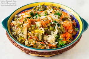 Close-up of vibrant Hyderabadi Veg Dum Biryani garnished with fried onions and coriander