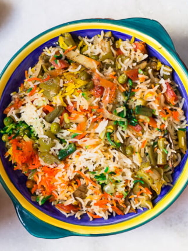 Top view of Veg Dum Biryani with visible saffron, mint, and fried cashews