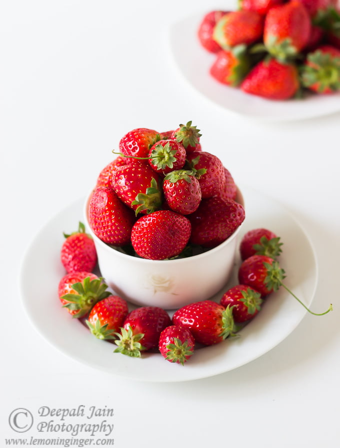 Fresh strawberries arranged in a white bowl