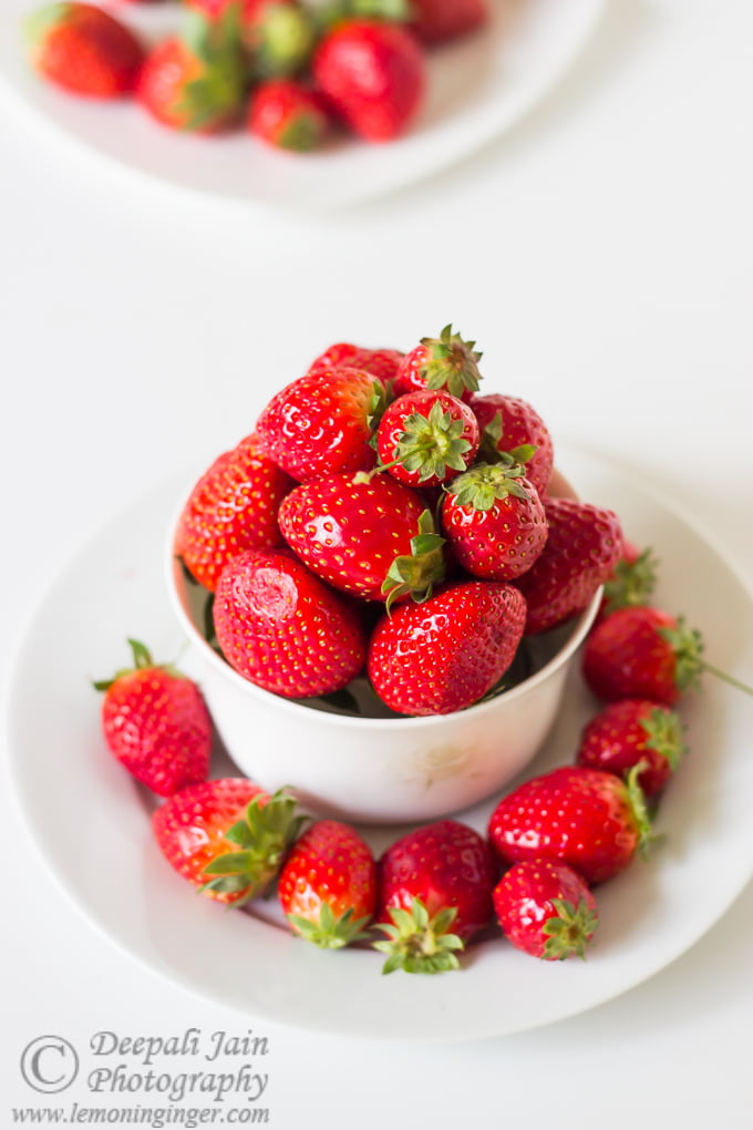 A bowl overflowing with freshly picked strawberries