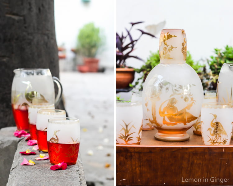 A chilled glass of Rooh Afza Sharbat next to a bottle of the iconic syrup