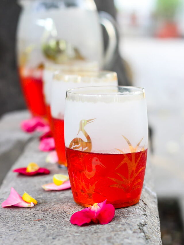 A refreshing glass of homemade Rooh Afza Sharbat garnished with mint leaves and ice cubes