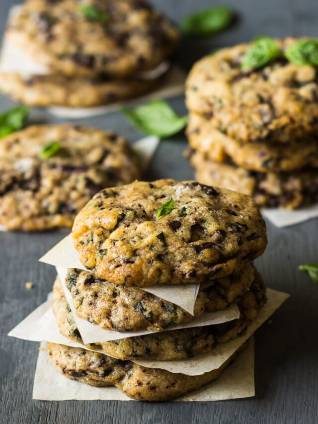 Freshly baked basil chocolate chunky cookies arranged on a cooling rack, showcasing their rich texture