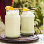 A refreshing glass of sweet lassi with a garnish of mangoes