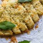 Close-up of melted cheese and herbs on freshly baked breadsticks