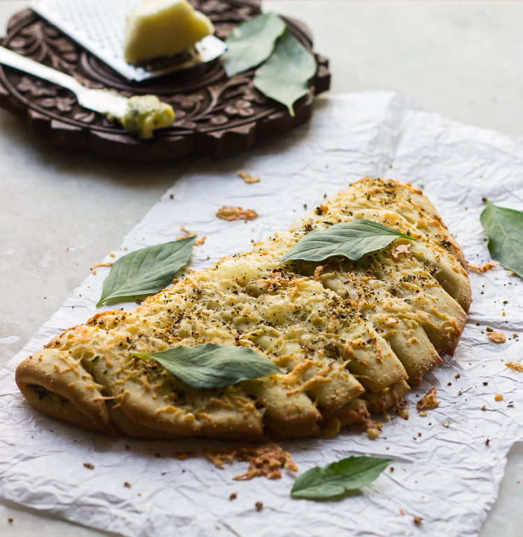 Stack of cheesy garlic breadsticks with crispy edges and soft center