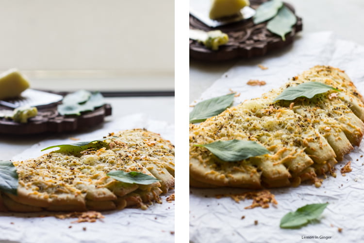Close-up of melted cheese and herbs on freshly baked breadsticks