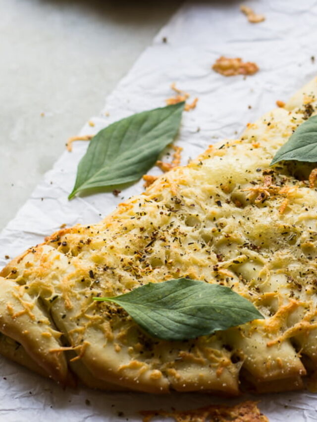 Golden brown cheesy garlic sticks served on a wooden platter