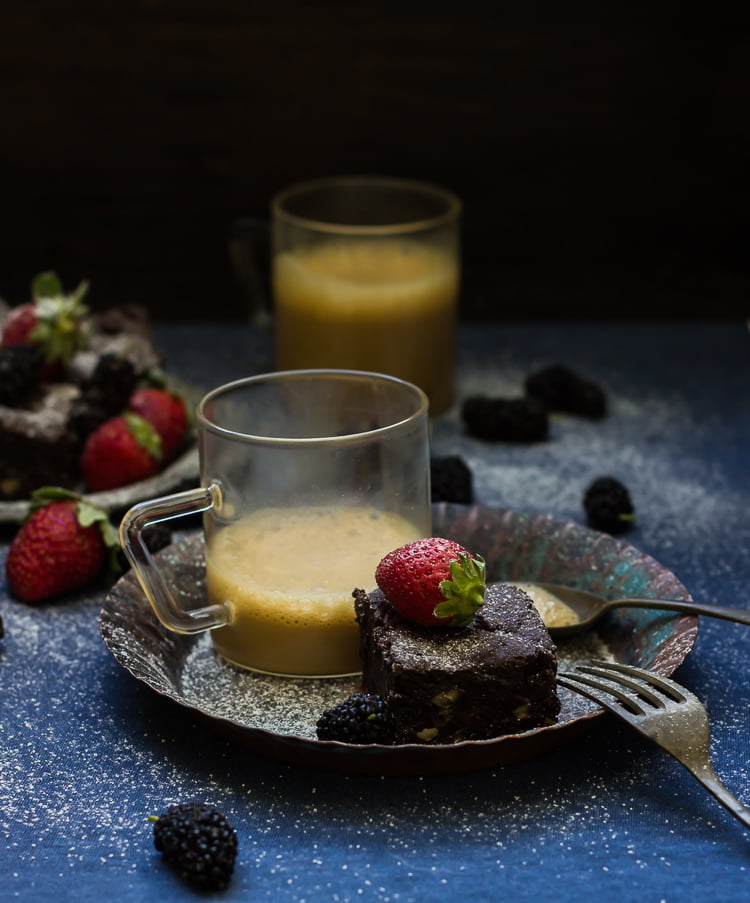 Close-up of fudgy wine-roasted strawberry brownies with a glossy chocolate top