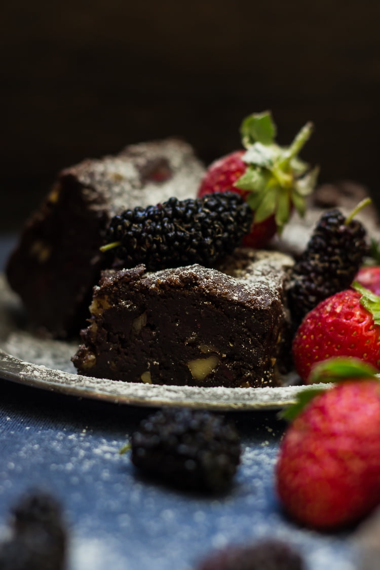 A bite-sized brownie showing the moist texture and strawberry filling
