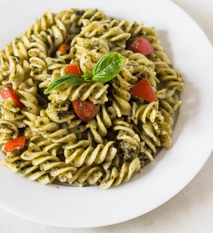 Close-up of creamy Sicilian pesto pasta with basil garnish