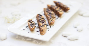 Freshly baked candied ginger cherry biscotti on a wire rack