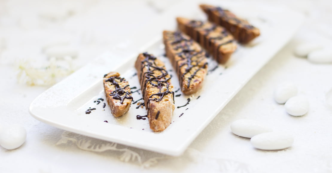 Freshly baked candied ginger cherry biscotti on a wire rack