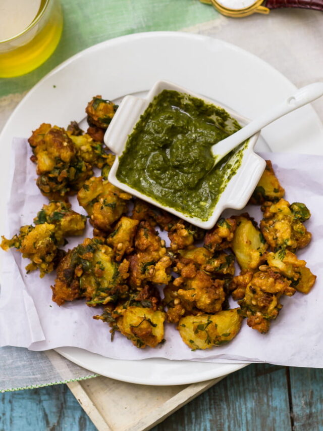 Freshly fried Aloo Bread Pakoris draining on a paper towel