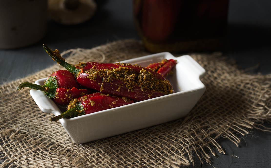 Close-up of Bharwan Lal Mirch ka Achar, highlighting the texture and filling inside the red chilies