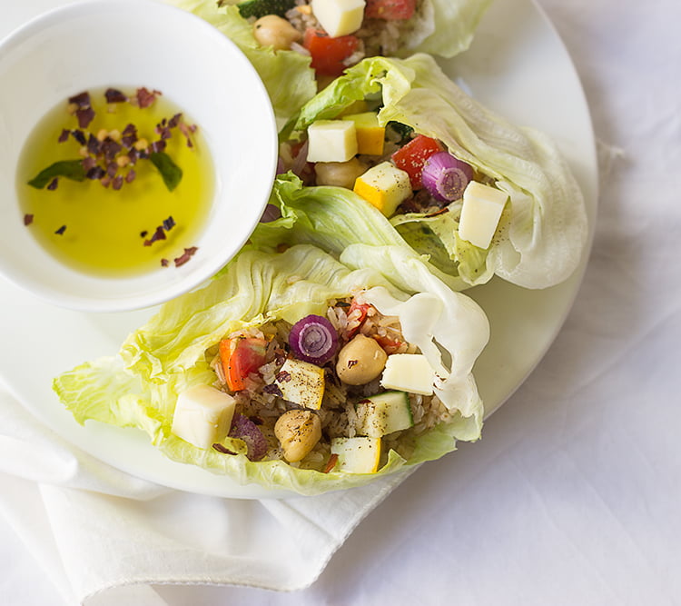 Brown rice lettuce wraps served on a white plate

