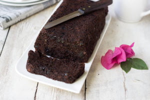 Sliced double chocolate zucchini bread on a wooden board