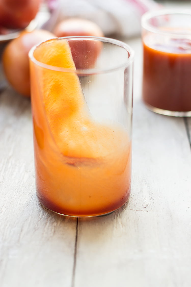 Pouring tomato ketchup into glass bottles