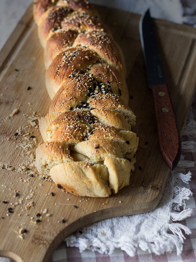 A single slice of challah bread topped with sesame seeds