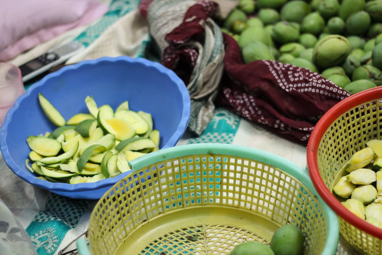A basket filled with chopped raw mangoes