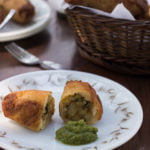 Bread rolls cut open to show spiced potato stuffing