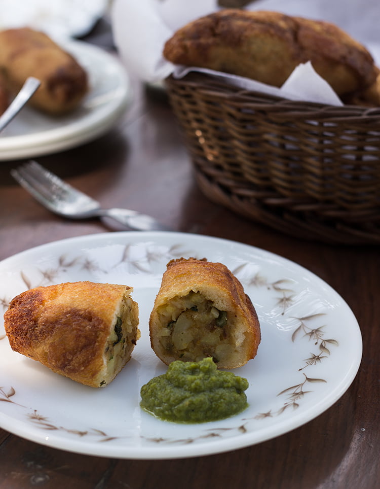 Golden brown potato stuffed bread rolls served on a plate