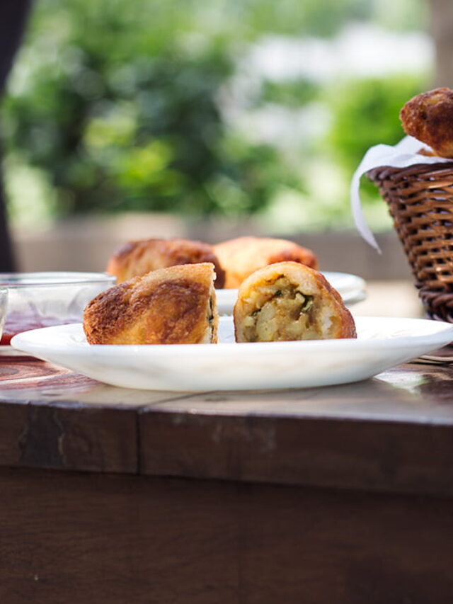 Golden brown potato stuffed bread rolls served on a plate