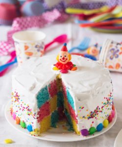 Layers of the Rainbow Checkerboard Cake being assembled