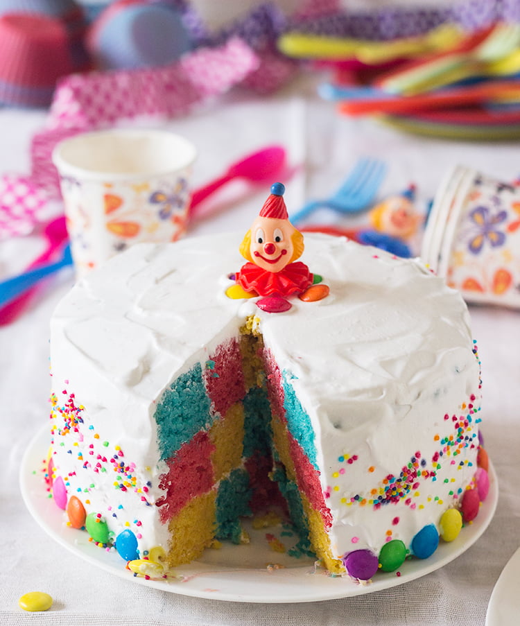 Layers of the Rainbow Checkerboard Cake being assembled