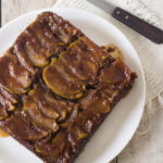 A beautiful top-down view of the whole cake with glistening caramelized apples