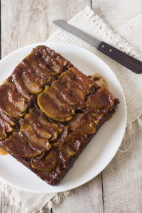 A beautiful top-down view of the whole cake with glistening caramelized apples