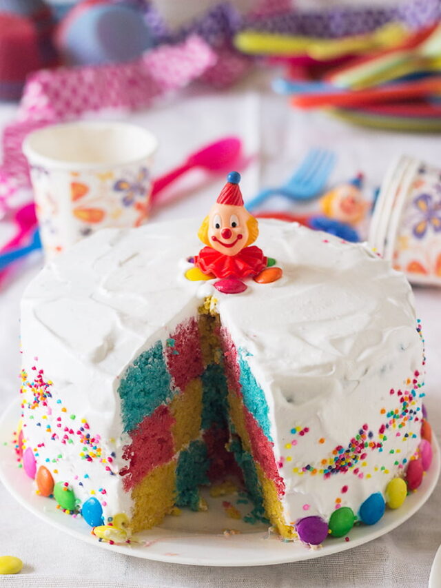 Layers of the Rainbow Checkerboard Cake being assembled