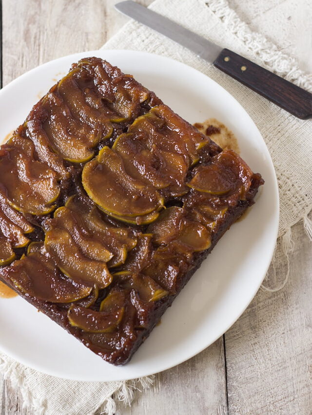 A beautiful top-down view of the whole cake with glistening caramelized apples