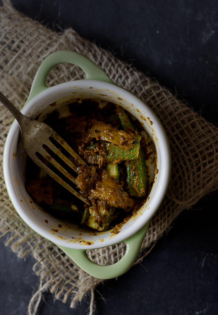 Bhindi Ka Achar served in a small dish, garnished with chili flakes