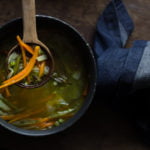Soup pot filled with simmering mixed vegetables in flavorful broth